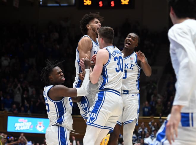 Dereck Lively II, second from left, celebrates with teammates Mark Mitchell, left, Kyle Filipowski, front, and Dariq Whitehead during this season's win against Pitt. 