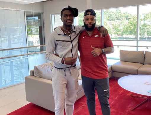 2023 cornerback RJ Johnson poses with Arkansas defensive backs coach Dominique Bowman.