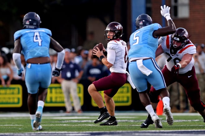 Sep 2, 2022; Norfolk, Virginia, USA; Virginia Tech Hokies quarterback Grant Wells (6) throws a pass against Old Dominion Monarchs defensive tackle Alonzo Ford Jr. (5) and defensive end Amorie Morrison (4) during the first quarter at Kornblau Field at S.B. Ballard Stadium. Mandatory Credit: Peter Casey-USA TODAY Sports