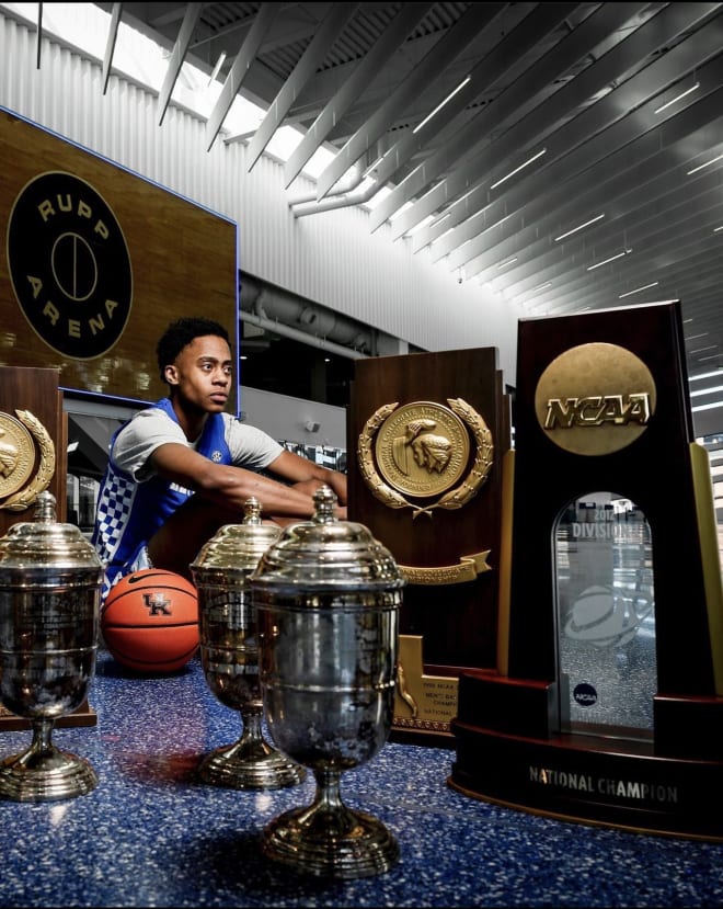 Tre Johnson posing with Kentucky's hardware during his official visit 