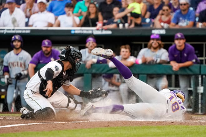 LSU first baseman Tre' Morgan (18) tries to score the go-ahead run and gets tagged out at home plate by Wake Forest catcher Bennett Lee (27) during the eighth inning of the Tigers' 3-2 loss in the College World Series on Monday night.