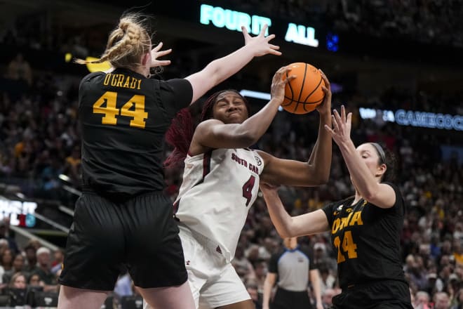 Mar 31, 2023; Dallas, TX, USA; South Carolina Gamecocks forward Aliyah Boston (4) controls the ball against Iowa Hawkeyes forward Addison O'Grady (44) and guard Gabbie Marshall (24) in the second half in semifinals of the women's Final Four of the 2023 NCAA Tournament at American Airlines Center.