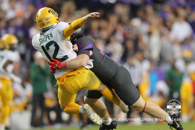 Blake Shapen takes a hit as he gets rid of the ball in a loss to TCU