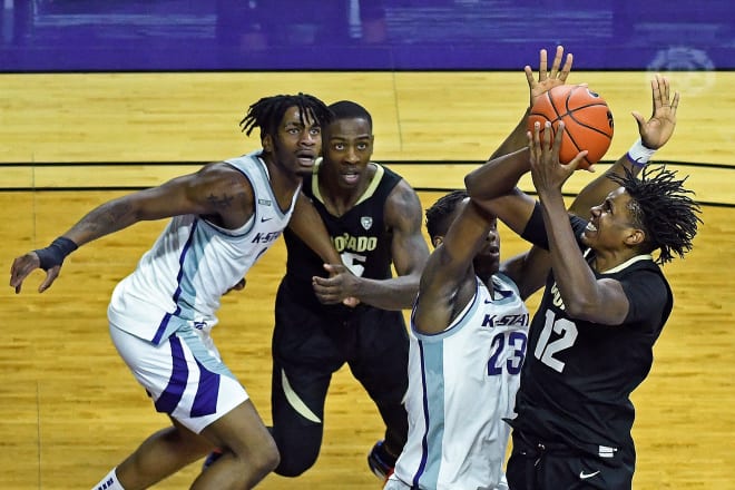 Colorado's Jabari Walker takes a contested shot, as McKinley Wright IV looks on