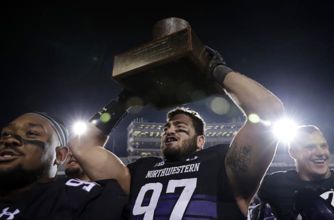 Joe Gaziano lifts the Land of Lincoln Trophy in 2018.