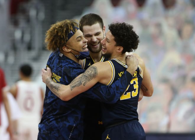 Michigan players celebrate after a huge comeback win at Wisconsin, following a three-week pause.