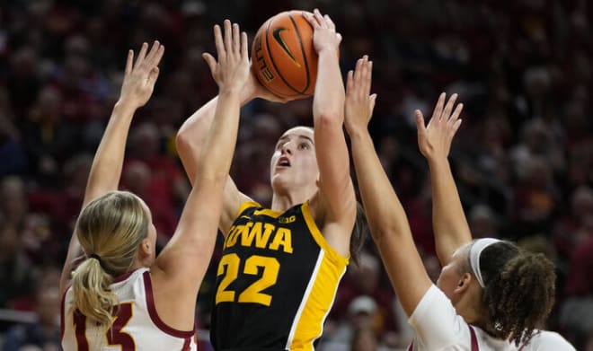 Caitlin Clark shoots over a pair of ISU defenders in Iowa's 67-58 win at Hilton Coliseum on Wednesday.