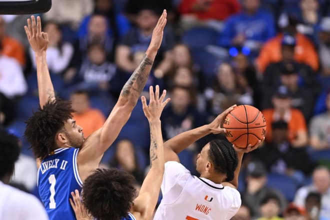 Duke's Dereck Lively II, left, goes up against Miami's Isaiah Wong on Friday night. 