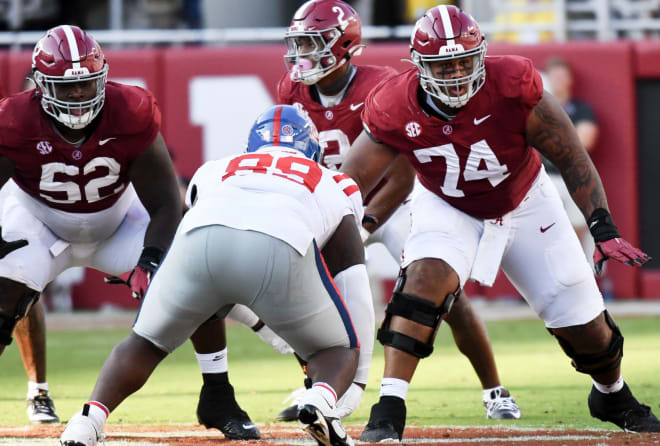 Alabama offensive linemen Tyler Booker (52) and Kadyn Proctor (74) prepare to block against Ole Miss. Photo | Alabama Athletics