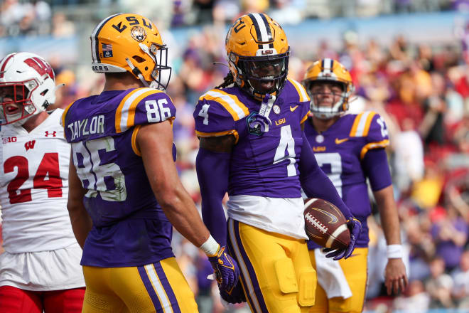 LSU Tigers running back John Emery Jr. (4) celebrates after scoring a touchdown against the Wisconsin Badgers in the second quarter during the ReliaQuest Bowl at Raymond James Stadium. Mandatory Credit: Nathan Ray Seebeck-USA TODAY Sports