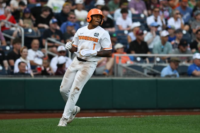 Jun 14, 2024; Omaha, NE, USA; Tennessee Volunteers second baseman Christian Moore (1) scores against the Florida State Seminoles during the first inning at Charles Schwab Filed Omaha. 