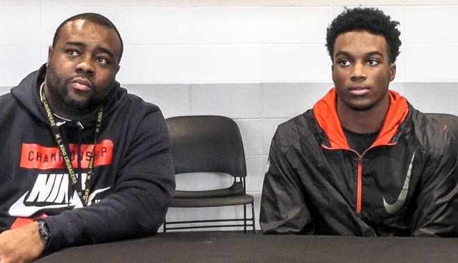 Detroit Martin Luther King head coach Tyrone Spencer and four-star cornerback Ambry Thomas during Thomas' small press conference.