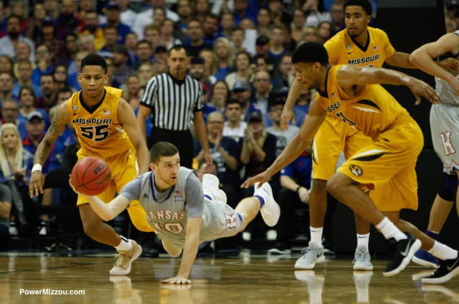 Kansas guard Svi Mykhailiuk dives for a loose ball during the Showdown For Relief charity exhibition game between Kansas and Missouri. 
