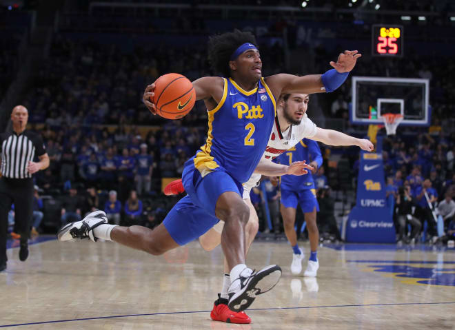 Pittsburgh Panthers Blake Hinson (2) prepares to go for a layup while driving past Louisville Cardinals Danilo Jovanovich (13) during the first half on February 17, 2024 at the Petersen Events Center in Pittsburgh, PA.