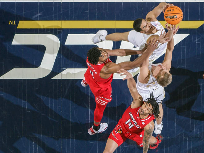 Notre Dame forward Paul Atkinson Jr. grabs one of his 15 rebounds against Louisville on Wednesday night.