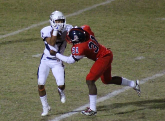 MJ Walker is all over Cienega running back Terrell Hayward in Friday night's quarterfinal. The Centennial defense had nine tackles for loss, three sacks, three fumble recoveries, and an interception in a 55-7 victory over the visiting Bobcats.
