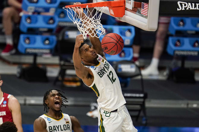 Baylor's Davion Mitchell (45) reacts as Jared Butler (12) gets a dunk against Wisconsin in the first half. 