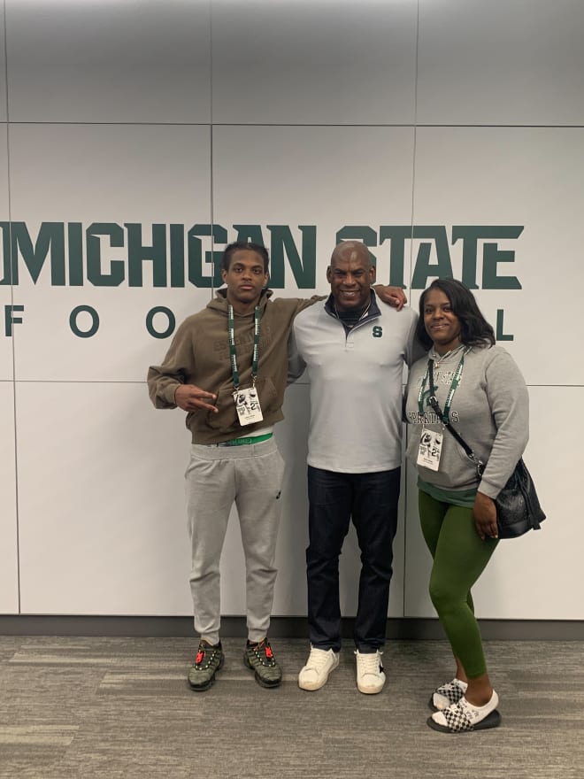 2025 athlete Cashus Shivers takes a photo with his mother and Michigan State head coach Mel Tucker (Photo courtesy of Cashus Shivers)