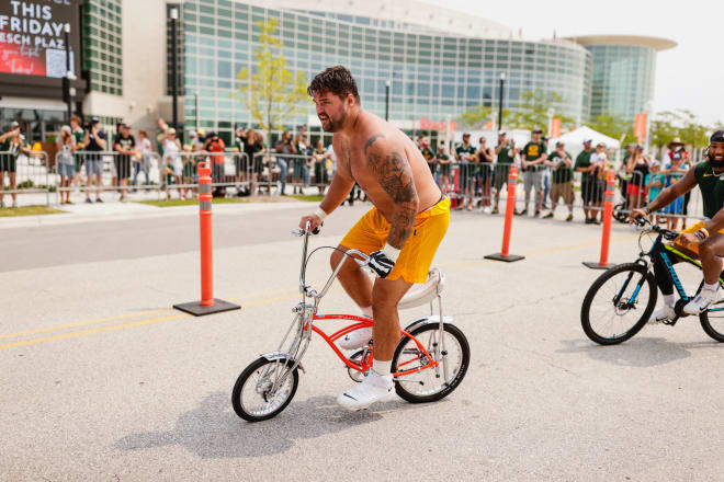 Stepaniak hangs on to an undersized bike during Green Bay's DreamDrive event. 