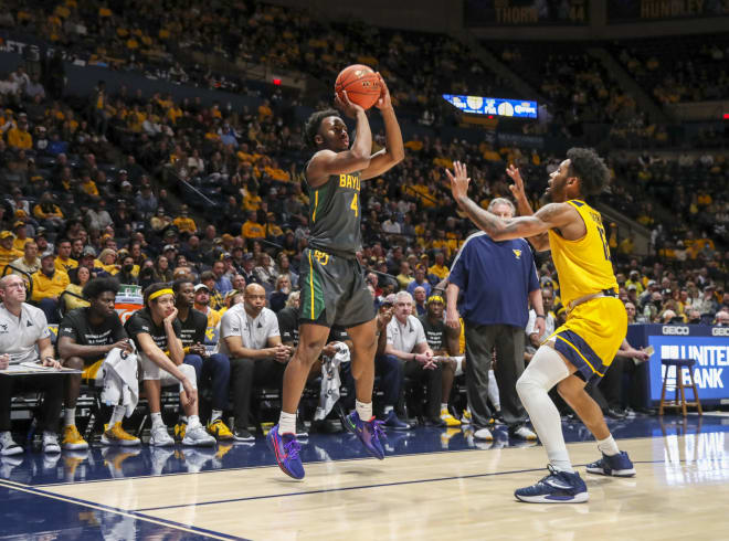 Baylor Bears guard LJ Cryer (4) shoots a three pointer over West Virginia Mountaineers guard Taz Sherman (12) during the first half at WVU Coliseum.
