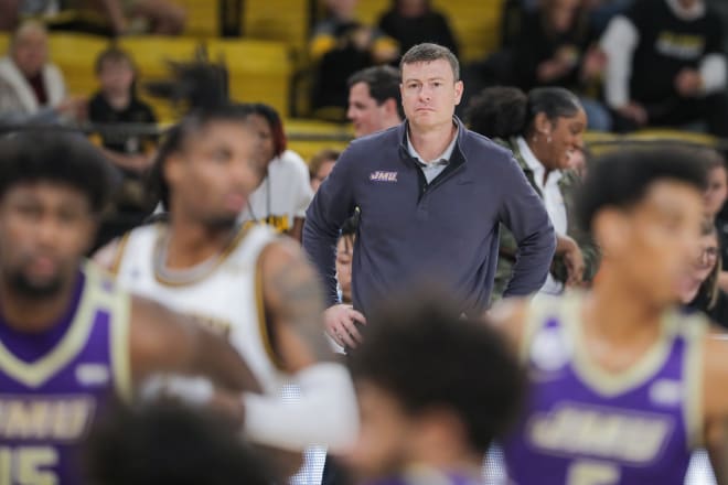 Mark Byington looks on during while coaching James Madison.