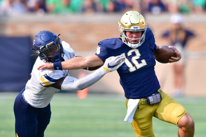 Tyler Buchner (12) helped Notre Dame in a tag-team role in 2021 more as a runner than a passer.