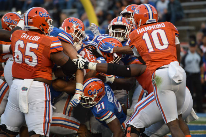 Florida's offense and defense battle as running back Jordan Scarlett pushes toward the end zone