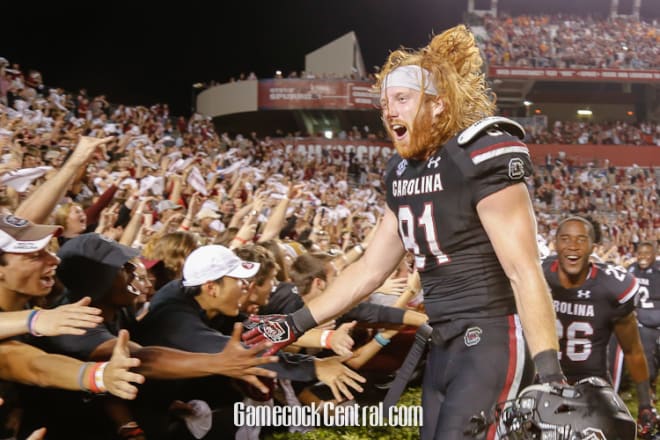 Hayden Hurst celebrates with the student section after South Carolina upsets No. 18 Tennessee.
