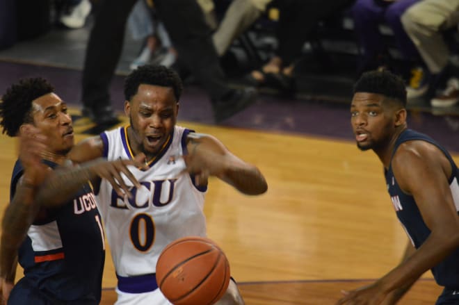 Isaac Fleming and UConn's Christian Vital battle for a loose ball in the first half of ECU's 82-73 senior day home loss.