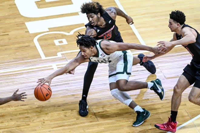 Michigan State's A.J. Hoggard, left, is pressured by Rutgers' Myles Johnson, center, and Geo Baker during the first half on Tuesday, Jan. 5, 2021, at the Breslin Center in East Lansing