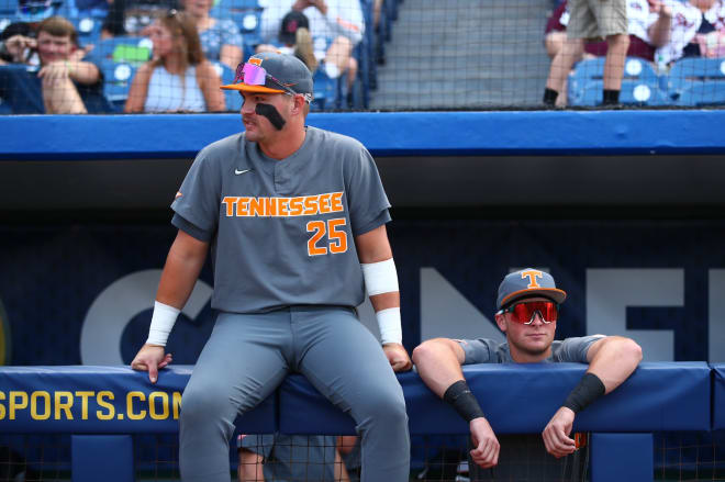 Tennessee infielder Blake Burke (25) and outfielder Dylan Dreiling sit in the dugout at Hoover Metropolitan Stadium ahead of the Vols' SEC Tournament game against Mississippi State on Friday. 