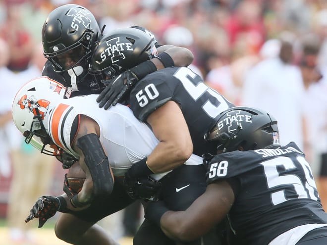Caleb Bacon (50) and JR Singleton (58) record a tackle against Oklahoma State.