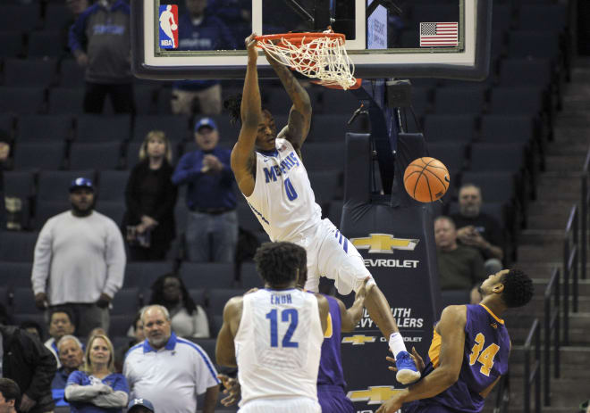 Memphis Tigers forward Kyvon Davenport (0) dunks the ball over two defenders at FedExForum.