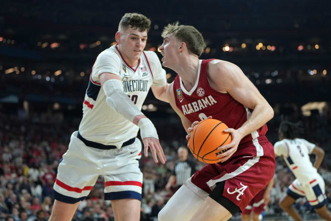 Alabama Crimson Tide forward Grant Nelson (2) controls the ball against Connecticut Huskies center Donovan Clingan (32) during the second half in the semifinals of the men's Final Four of the 2024 NCAA Tournament at State Farm Stadium. Photo | Bob Donnan-USA TODAY Sports