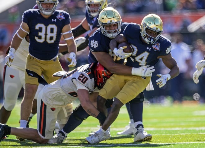 Notre Dame running back Jadarian Price (24) gets a friendly shove from Irish offensive tackle Charles Jagusah during Friday's Sun Bowl rout.