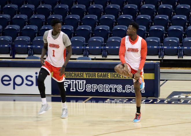 Emmanuel Akot and Fallou Diagne stretch to get loose ahead of Thursday's game