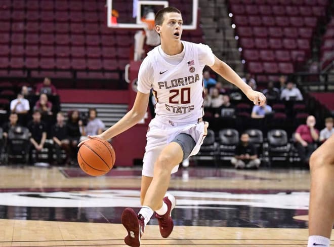 Walk-on guard Travis Light dribbles the ball up court during the 2019-20 season.