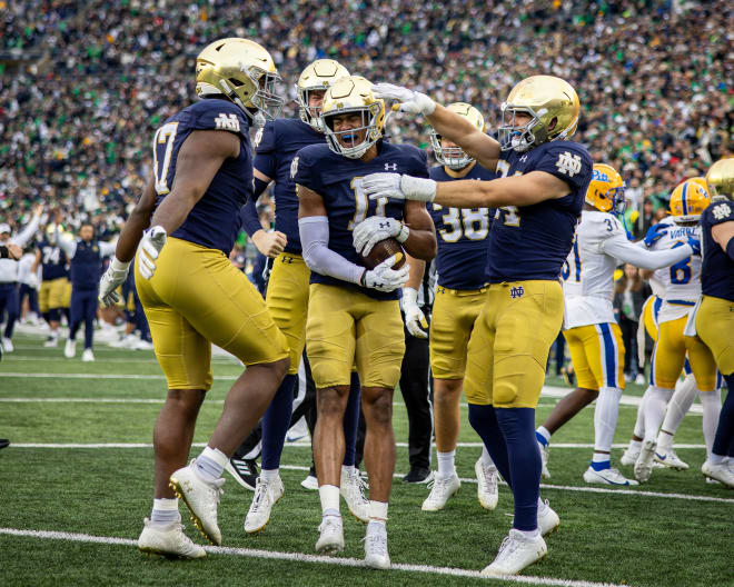 Notre Dane safety Ramon Henderson (11) celebrates his special teams TD against Pitt with his Irish teammates.