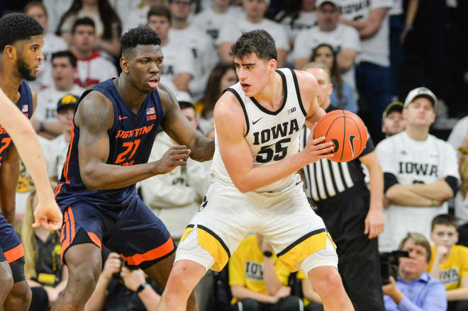 Iowa Hawkeyes center Luka Garza (55) is defended by Illinois Fighting Illini center Kofi Cockburn (21) during the first half at Carver-Hawkeye Arena.