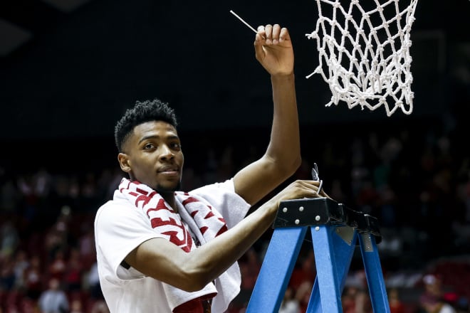Alabama Crimson Tide forward Brandon Miller (24) celebrates regular season SEC champions by cutting down the net after an NCAA basketball game against the Auburn Tigers at Coleman Coliseum. Photo | Butch Dill-USA TODAY Sports