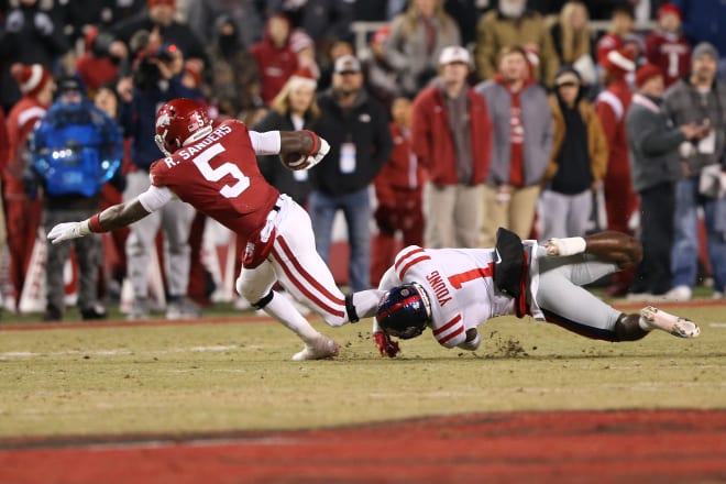 Ole Miss defensive back Isheem Young tackles Arkansas running back Rocket Sanders during the Rebels' loss to the Razorbacks Saturday night in Fayetteville. 