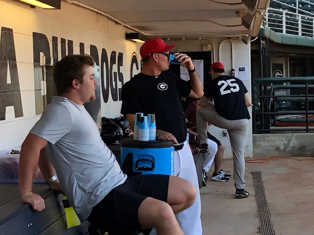 Zac Kristofak and pitching coach Sean Kenny take a break prior to a recent practice.