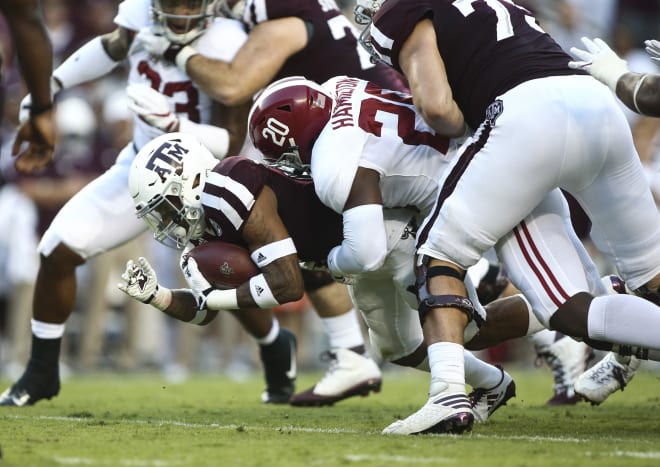 Texas A&M Aggies running back Trayveon Williams (5) runs with the ball as Alabama Crimson Tide linebacker Shaun Dion Hamilton (20) attempts to make a tackle during the first quarter at Kyle Field. Photo | Troy Taormina-USA TODAY Sports
