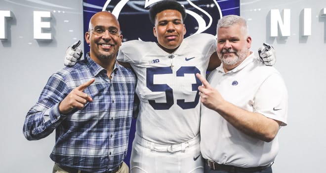 Dawkins (center) poses with James Franklin and Matt Limegrover during a visit in April.