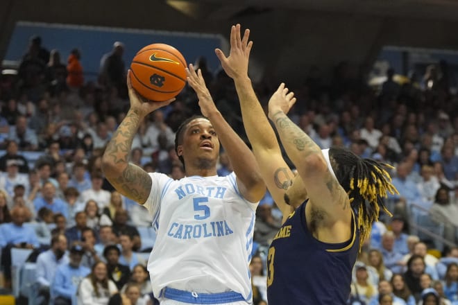 North Carolina's Armando Bacot (5) shoots over Notre Dame's Dom Campbell during UNC's 81-64 romp on Saturday.