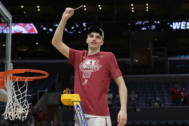 Alabama Crimson Tide forward Grant Nelson (2) cuts down the net after defeating the Clemson Tigers in the finals of the West Regional of the 2024 NCAA Tournament at Crypto.com Arena. Photo | Jayne Kamin-Oncea-USA TODAY Sports