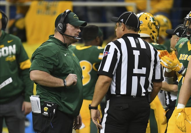 North Dakota State coach Matt Entz, left, talks with an official during the Bison's win over Nicholls State in the second round of the FCS playoffs last month at the FargoDome in Fargo, N.D.