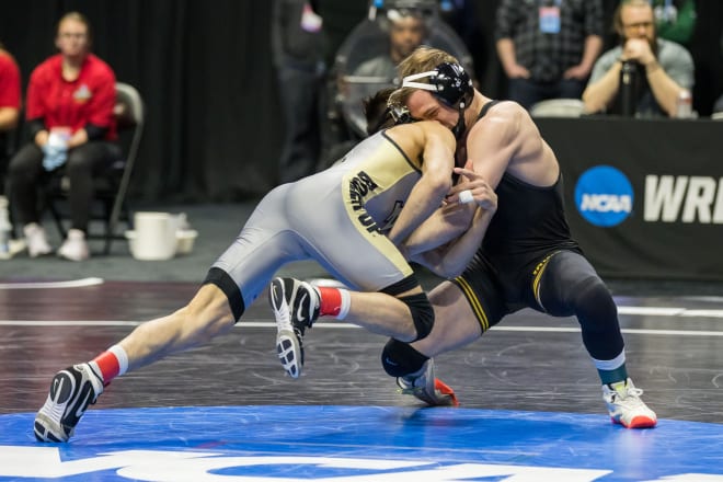 Purdue's Matt Ramos attacks Iowa's Spencer Lee during the NCAA Tournament semifinals at 125 lbs.