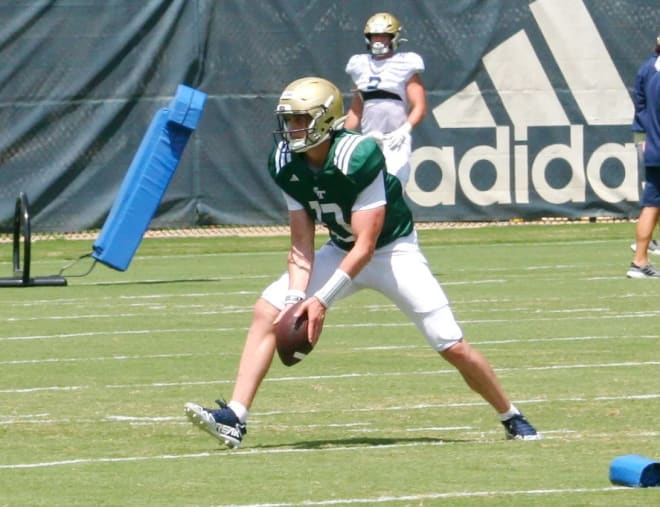 Haynes King prepares to pitch the ball during practice