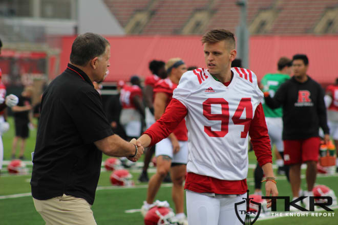 Rutgers P Adam Korsak shaking hands with head coach Greg Schiano